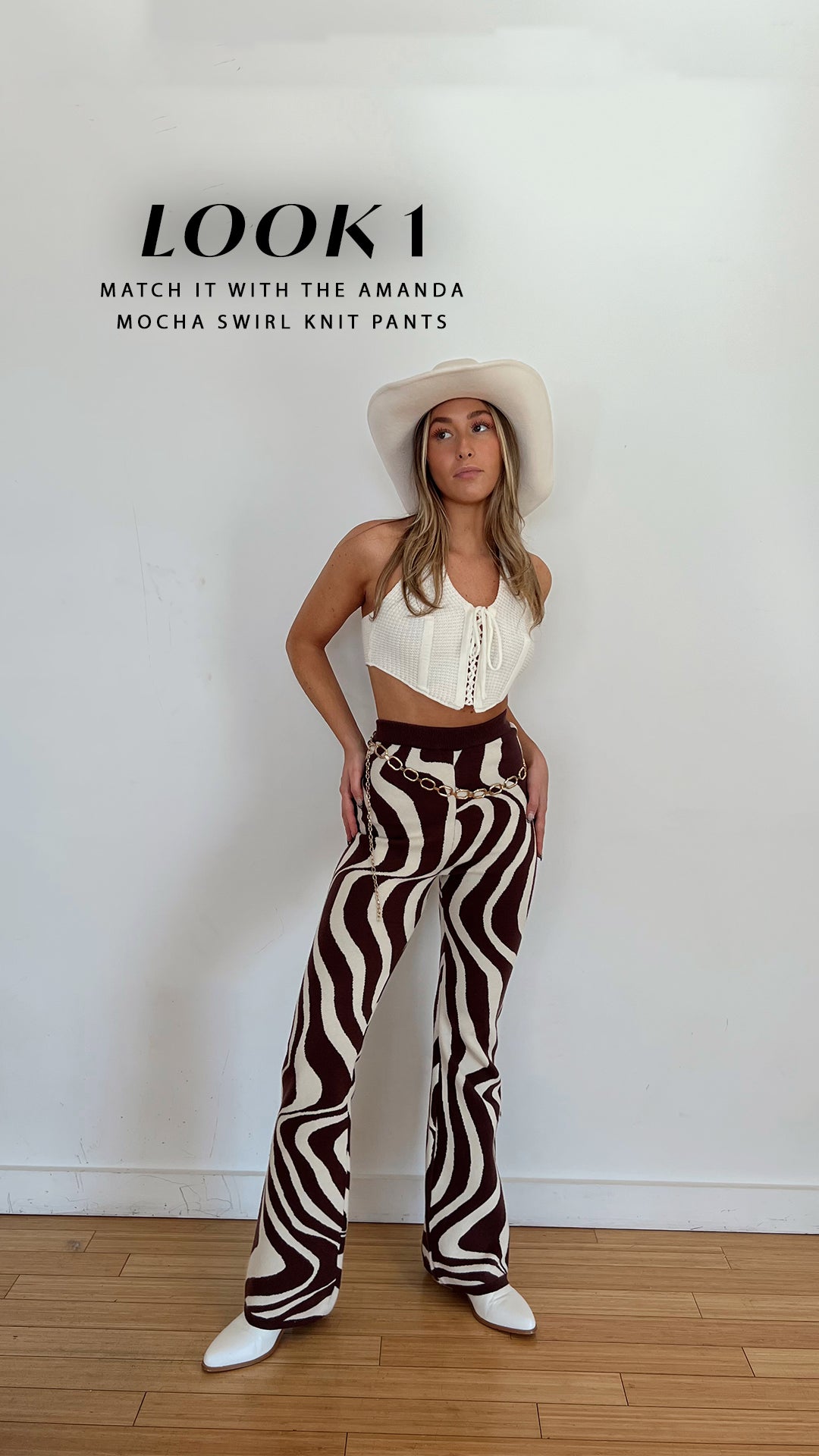 Look 1: white Amalfi crochet top styled with mocha swirl knit pants and cowboy hat.