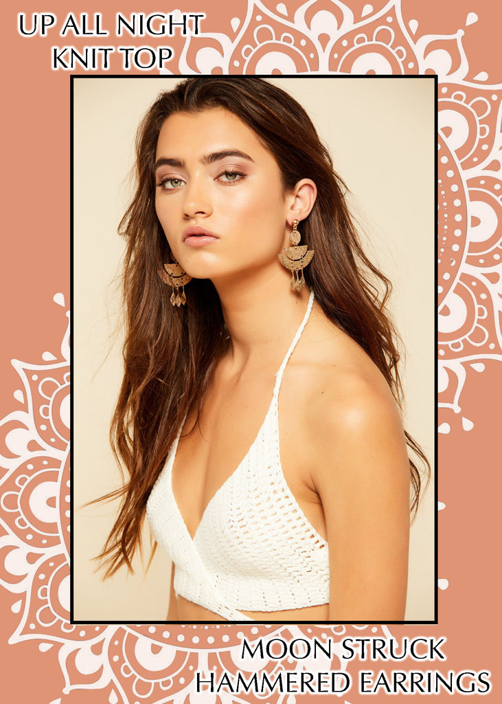 Model in white crochet halter top with gold hammered earrings, a women's festival fashion look.