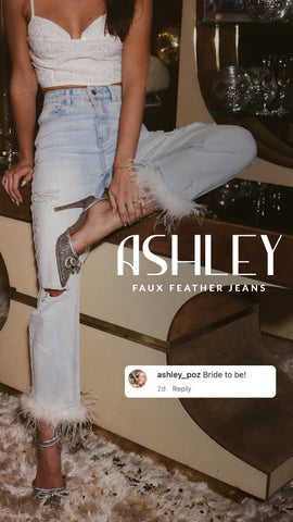 Light wash distressed faux feather jeans styled with a white lace crop top and snakeskin heels.