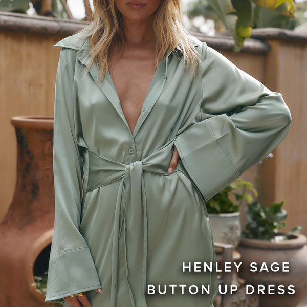 Sage green satin button-up dress with a tie waist, styled outdoors beside terracotta planters.