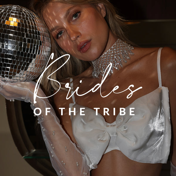 Bachelorette party look: white bow top, rhinestone choker, and pearl gloves with a disco ball.