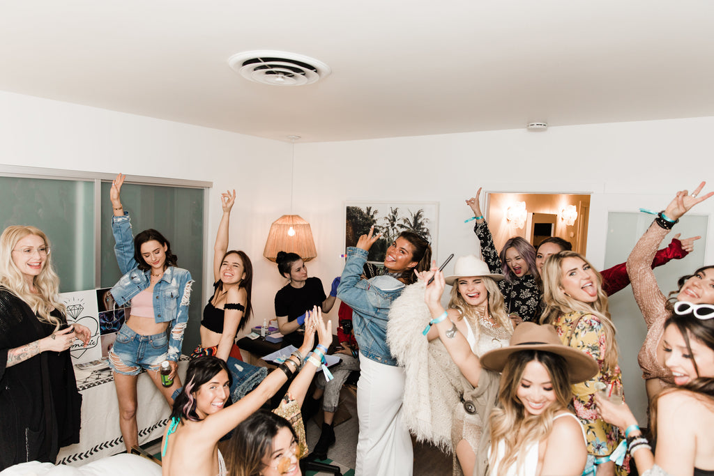 Group celebrating in festival fashion at 12th Tribe and Chinese Laundry Coachella event.