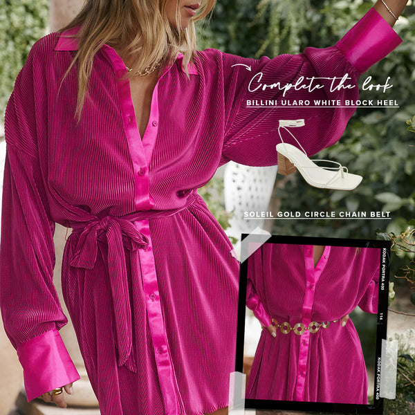 Fuchsia pleated plissé shirt dress with tie waist, styled with white heels and gold chain belt.