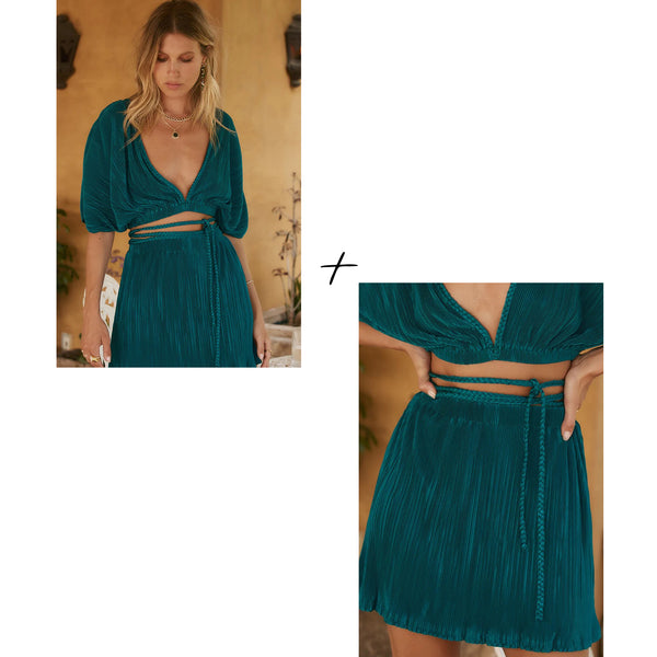 Teal pleated crop top and matching skirt styled as a summer resort outfit.